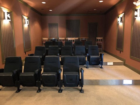 A row of black chairs are arranged in a room with brown walls at The Legends at Steeplechase Apartments, Richwood, 41094
