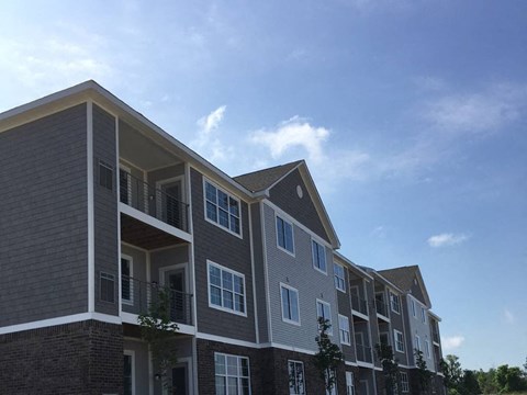 A multi-story residential building with balconies and windows.