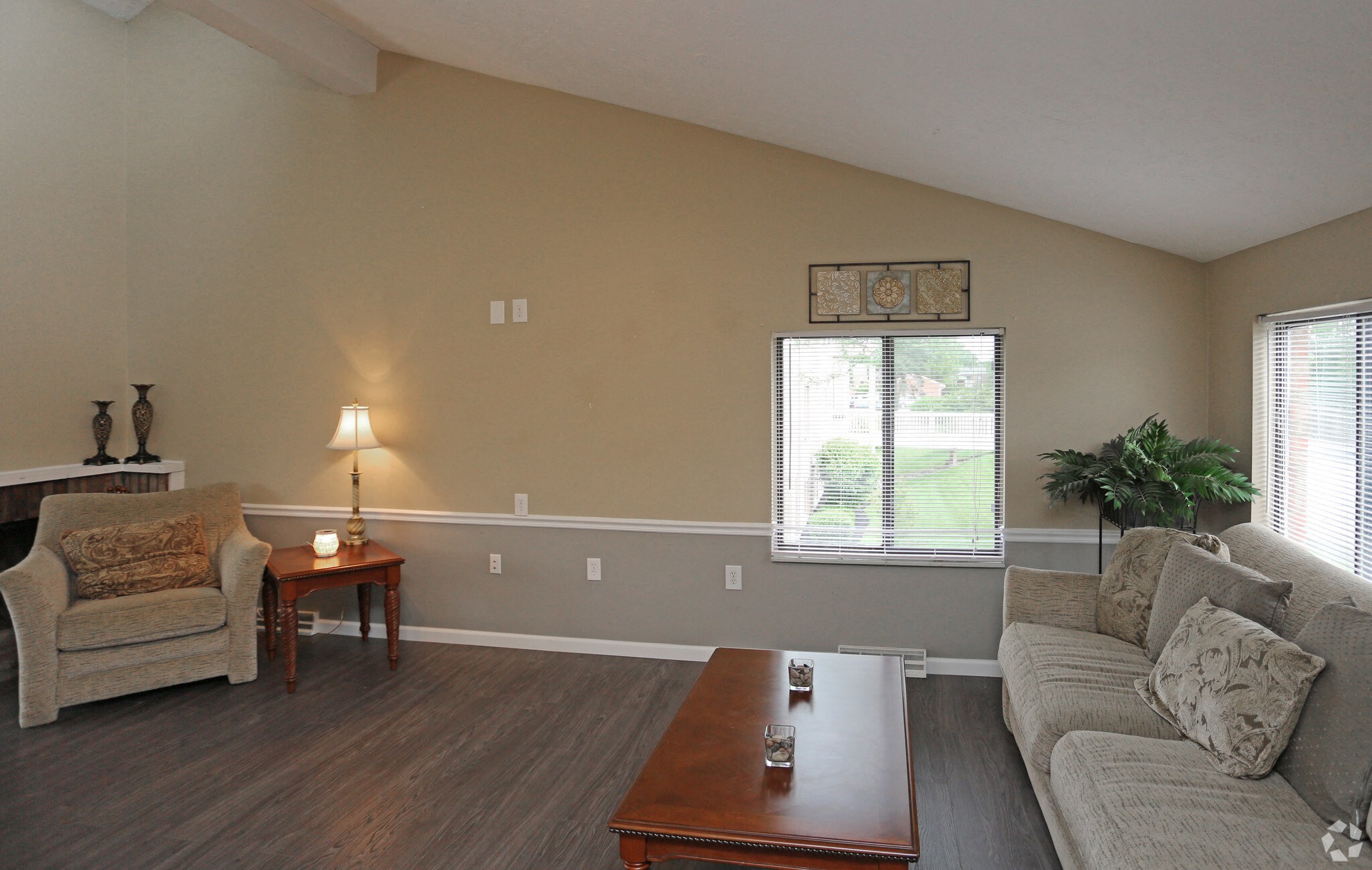 A living room with a couch, chair, and coffee table.