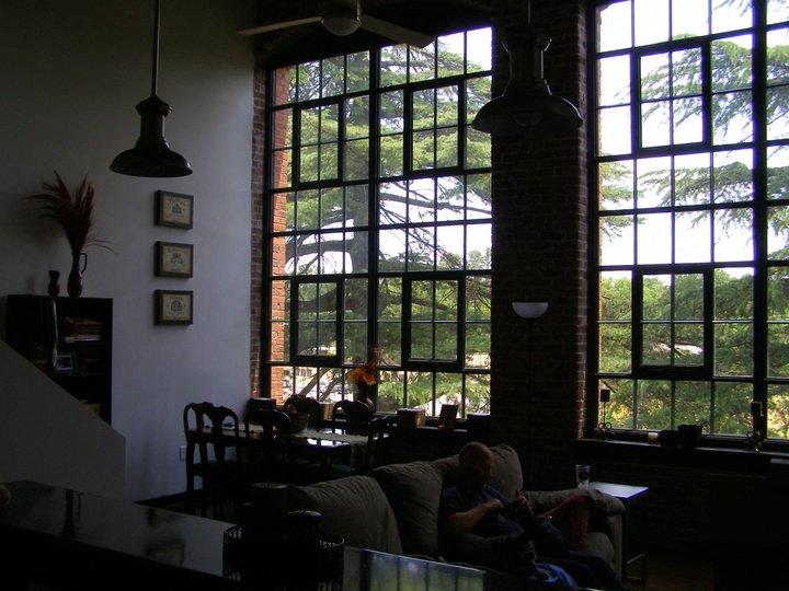a man sitting on a couch in front of a large window