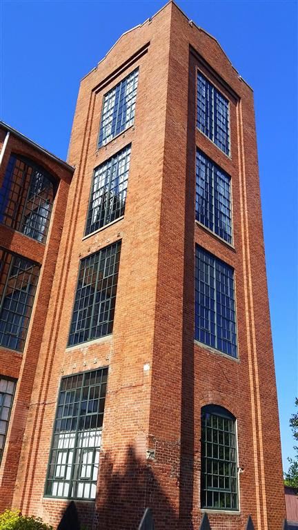 a tall brick building with tall windows