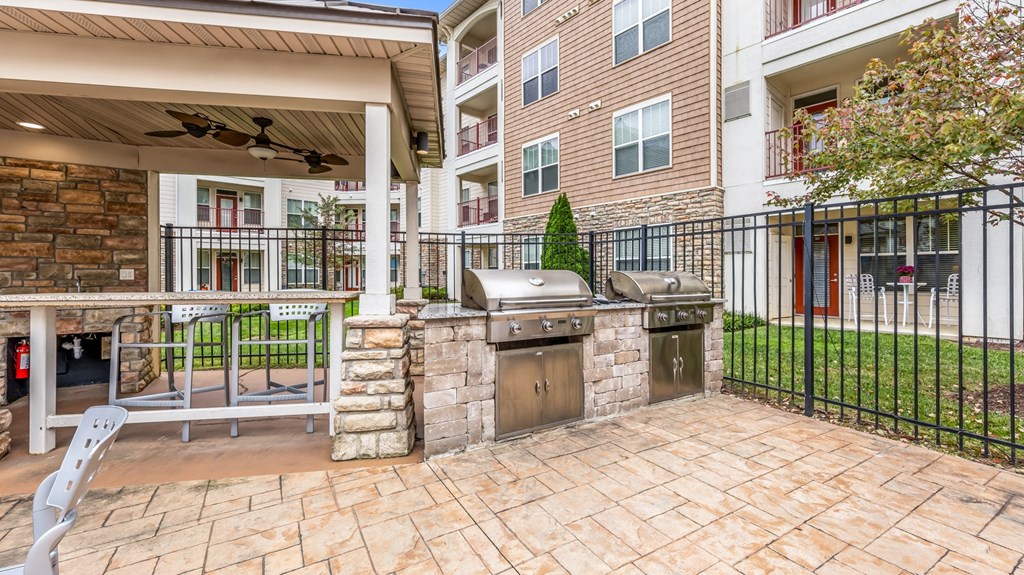 the preserve at ballantyne commons spacious outdoor patio with grill and stone wall at Vanguard Crossing, Missouri 63124