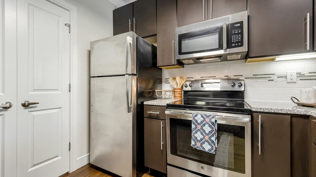 a kitchen with stainless steel appliances and a stainless steel refrigerator at Vanguard Crossing, Missouri 63124