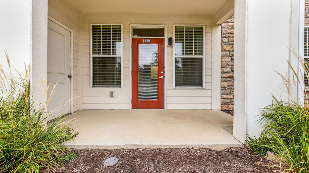 the entrance to a house with a red door at Vanguard Crossing, Missouri