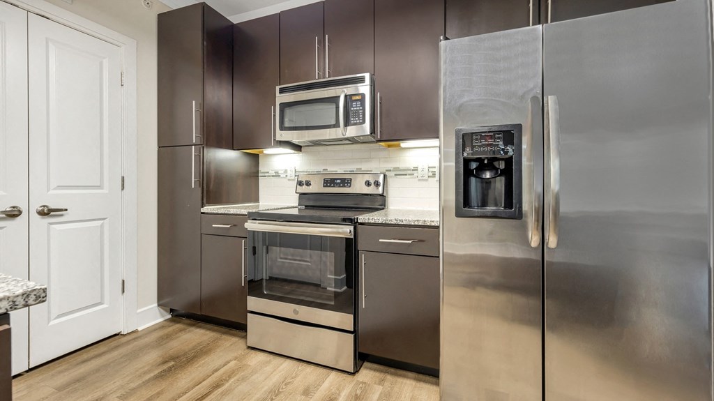 a kitchen with stainless steel appliances and a stainless steel refrigerator at Vanguard Crossing, St. Louis, MO