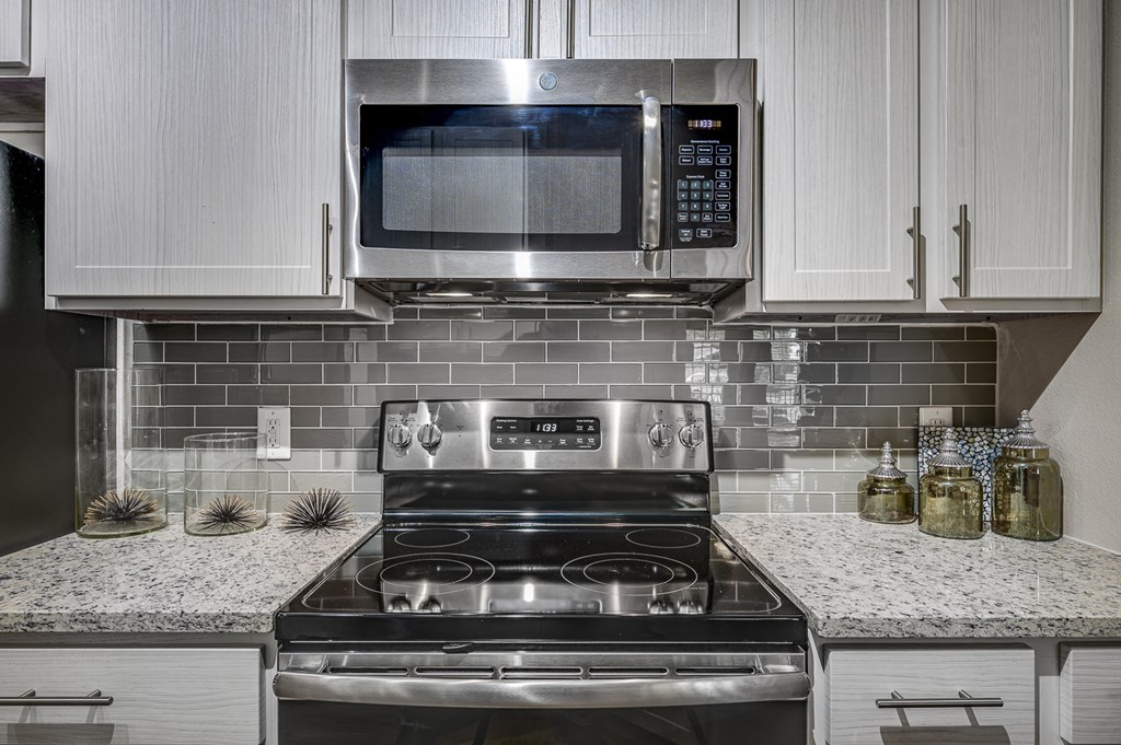 Electric Range In Kitchen at Riachi at One21, Plano, Texas