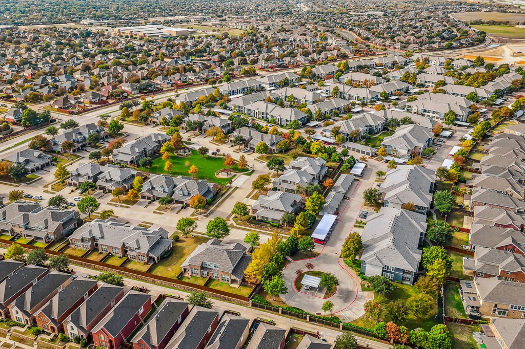 an aerial view of a neighborhood with houses and trees