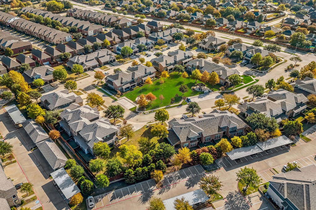an aerial view of a neighborhood with houses and trees