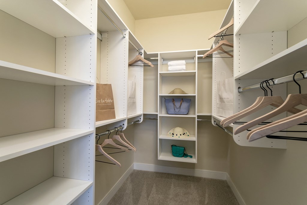 a walk in closet with shelves and shoes at Aster Apartments, Ohio, 44122