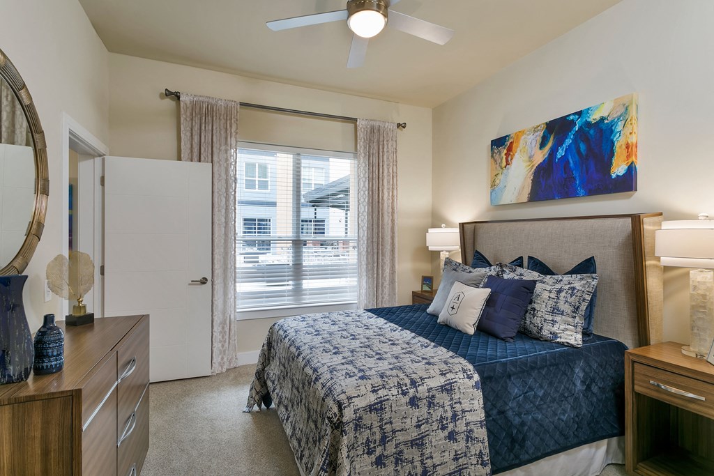 a bedroom with a bed and a ceiling fan at Aster Apartments, Beachwood, 44122