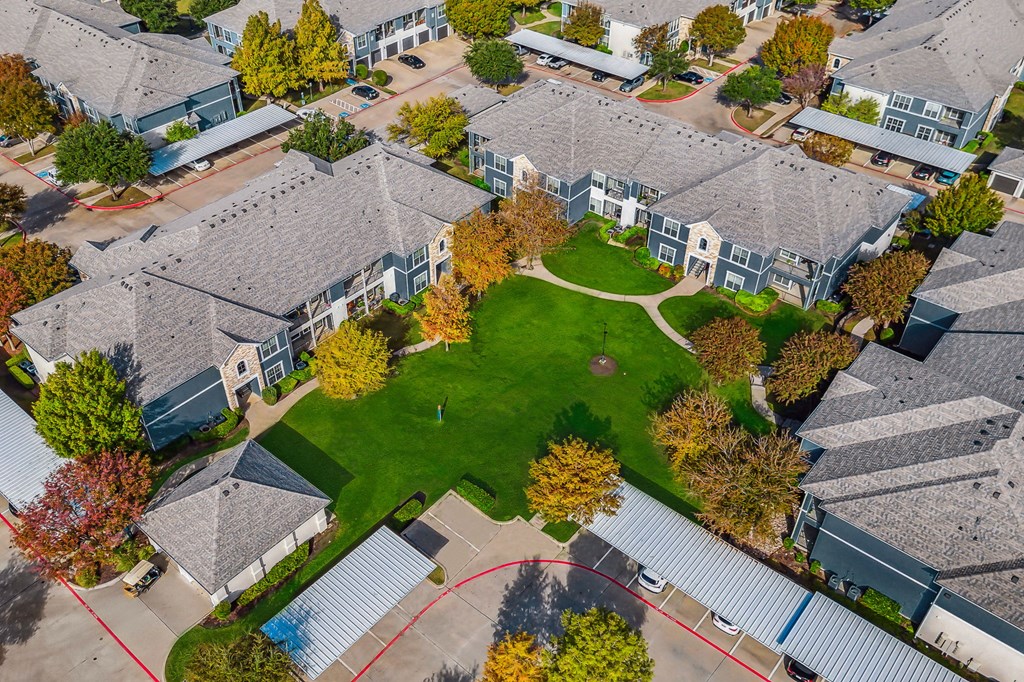 an aerial view of a neighborhood with houses and a green lawn