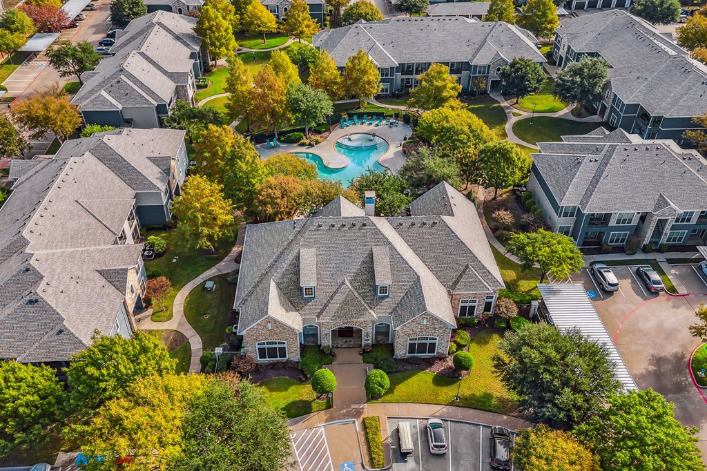 an aerial view of a neighborhood with houses and a swimming pool