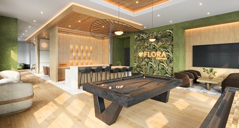 A pool table is in the middle of a room with a green wall and a sign that says "OFLORA".