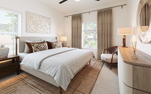 A bedroom with a large bed and a ceiling fan.