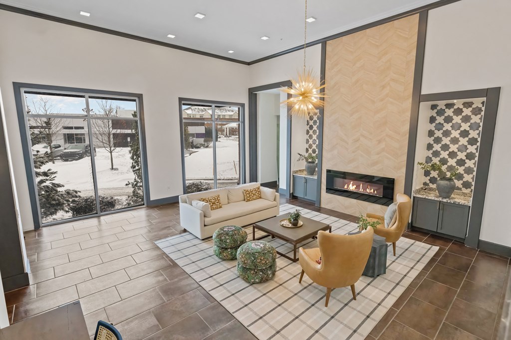 A living room with a fireplace and a large window at Aster Apartments, Ohio, 44122