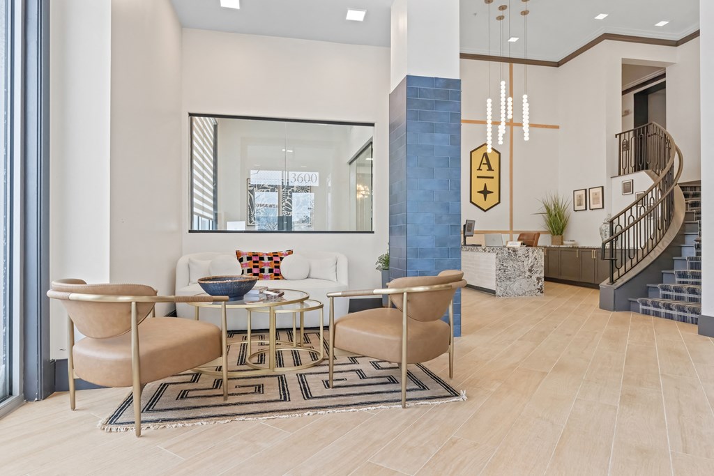 A modern living room with a glass table and chairs at Aster Apartments, Beachwood, OH