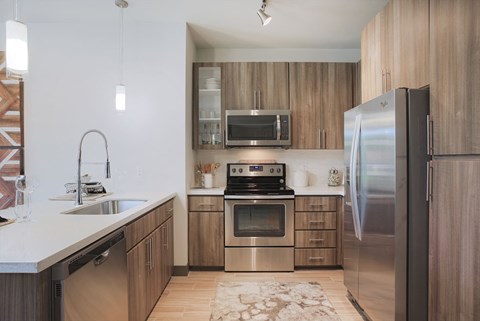 a kitchen with stainless steel appliances and wooden cabinets