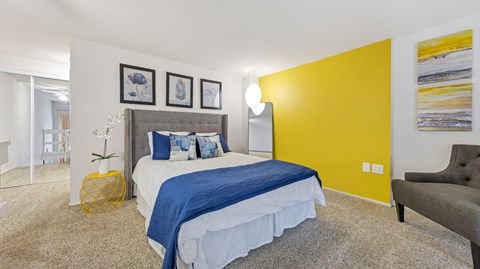 a bedroom with a yellow accent wall and a bed at Park 44, St. Louis, 63108