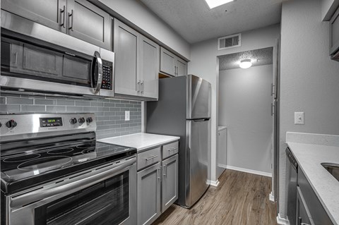 a kitchen with stainless steel appliances and white cabinets