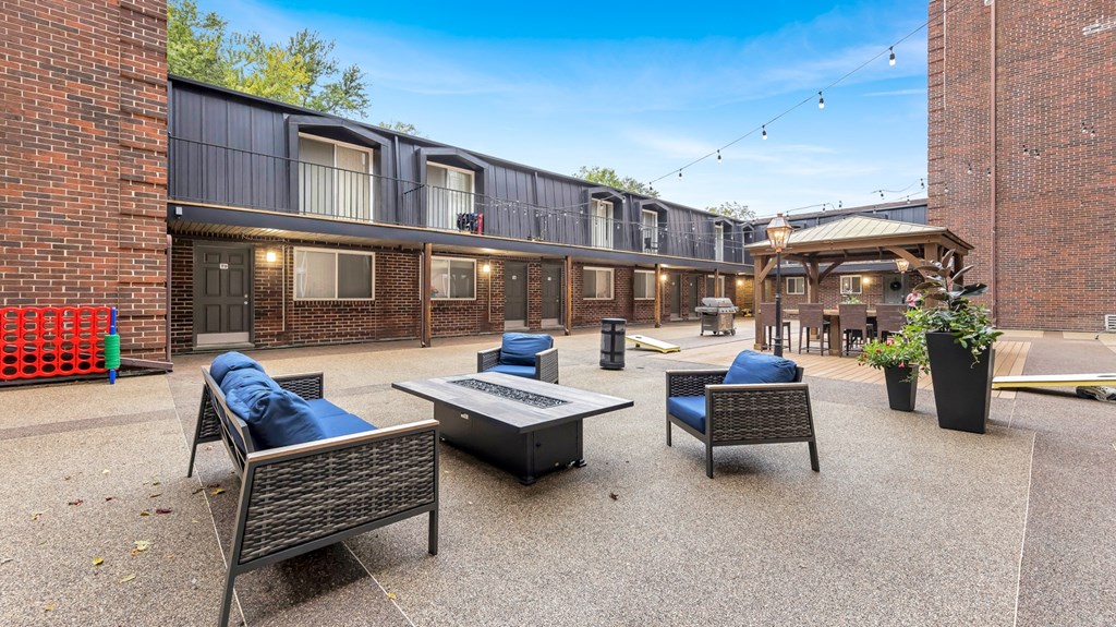 a patio with furniture and a fire pit