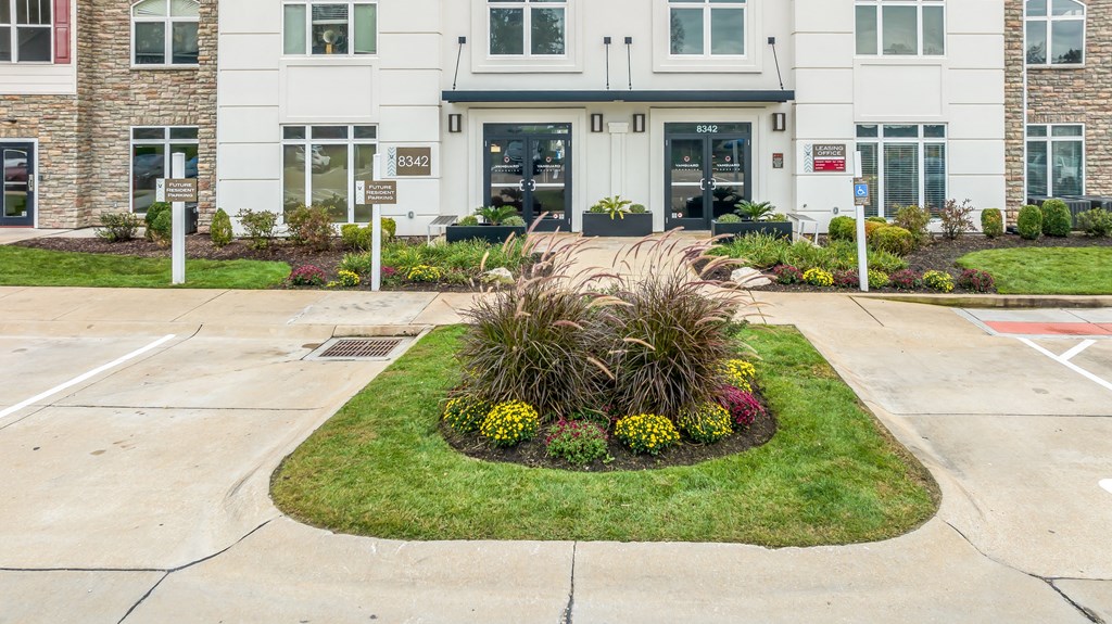 a flower garden in front of a building at Vanguard Crossing, St. Louis, 63124