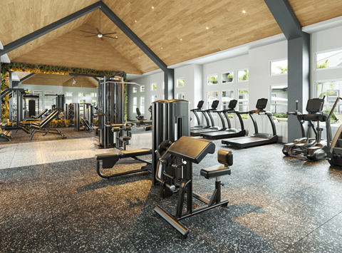 A gym with a variety of equipment including treadmills, weights, and exercise machines.