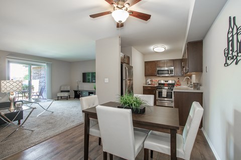 an open kitchen and dining room with a wooden table and chairs