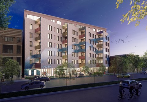 A modern apartment building with a bicycle parked in front.