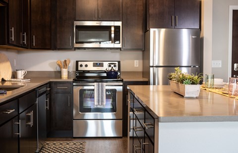 a kitchen with stainless steel appliances and wooden cabinets