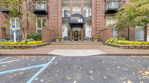 the entrance to a brick building with a parking lot in front of it at Park 44 Apartments in St. Louis, MO, 63108