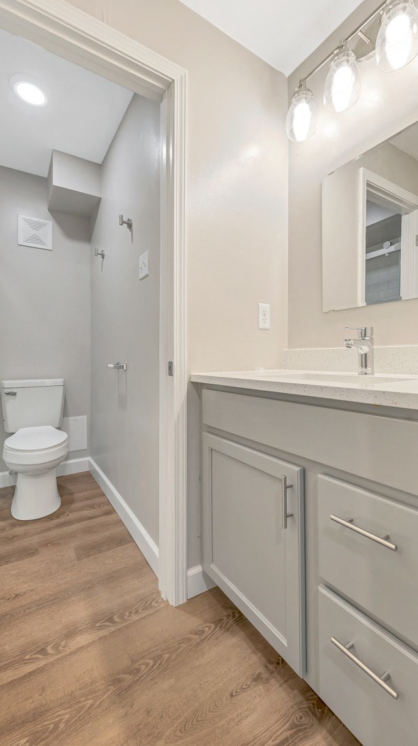 a bathroom with a toilet and a sink and a mirror