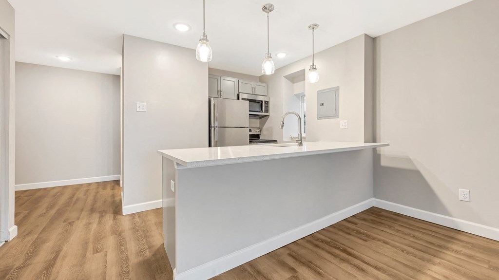 a kitchen with a large counter top and a refrigerator