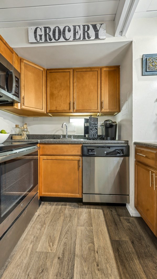 a kitchen with stainless steel appliances and wooden cabinets