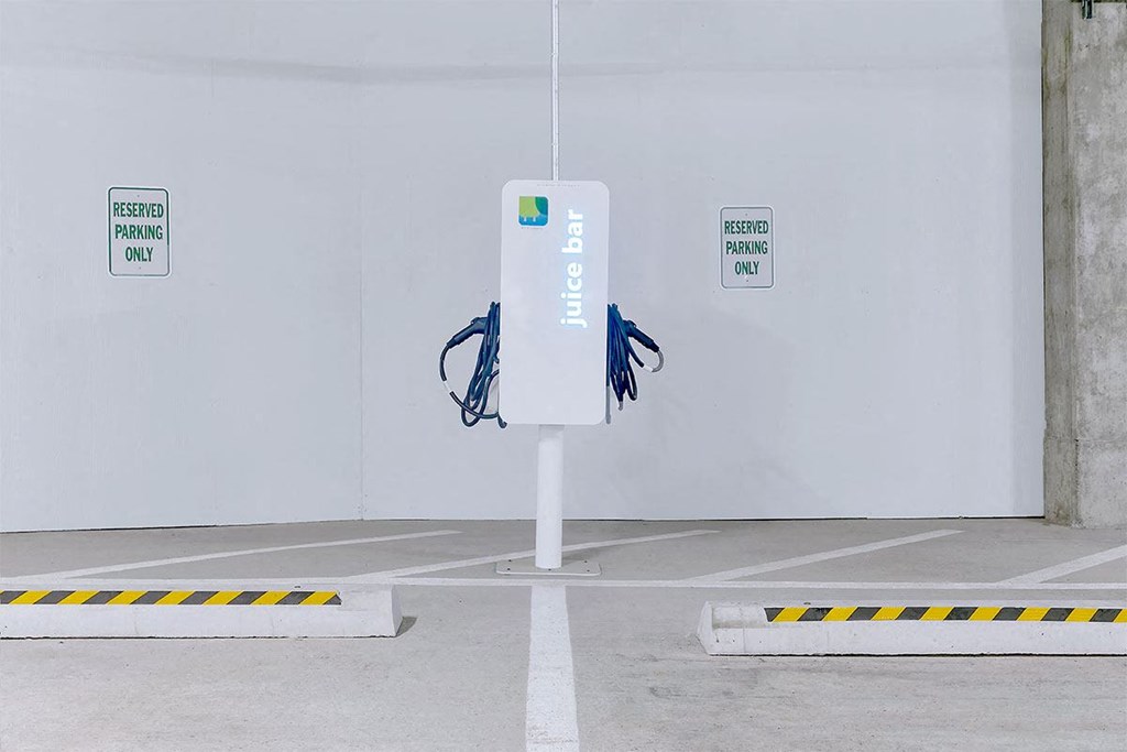 a parking meter in the middle of a parking lot at Aster Apartments, Beachwood, OH 44122