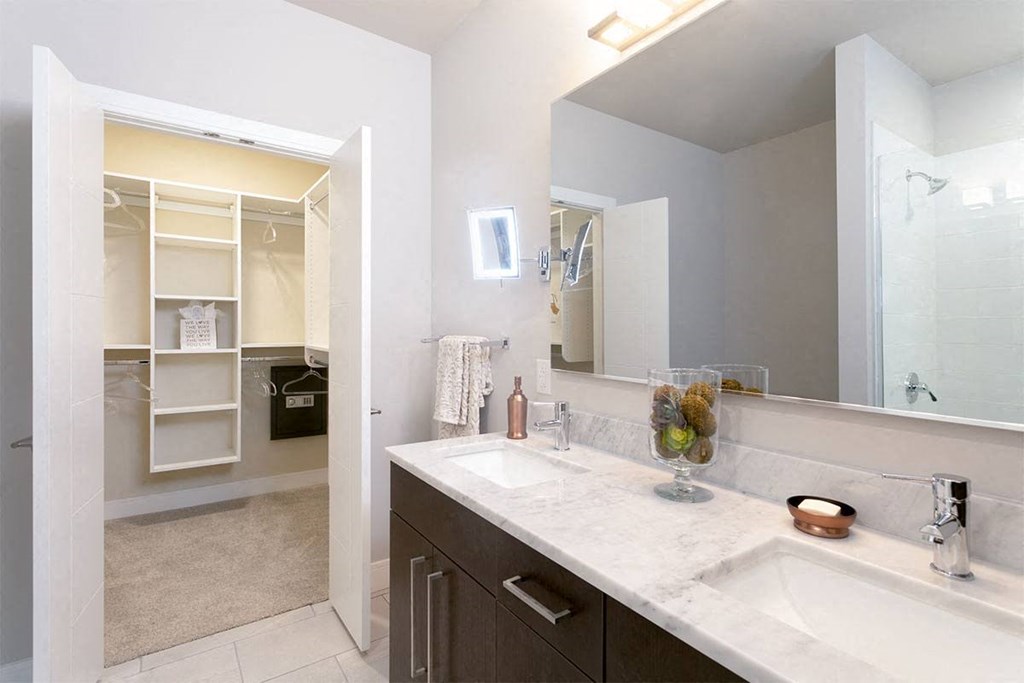 a kitchen with a white counter top and a window at Aster Apartments, Beachwood, OH