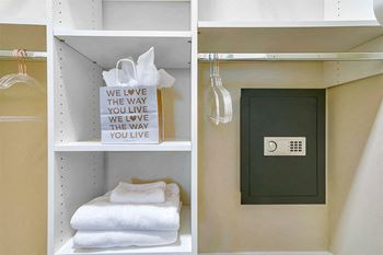 a shelf with towels and a door in a bathroom at Aster Apartments, Beachwood Ohio
