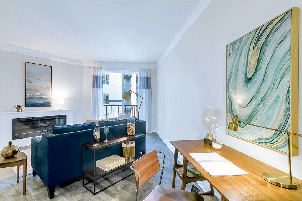 a living room with a blue couch and a fireplace at Aster Apartments, Ohio