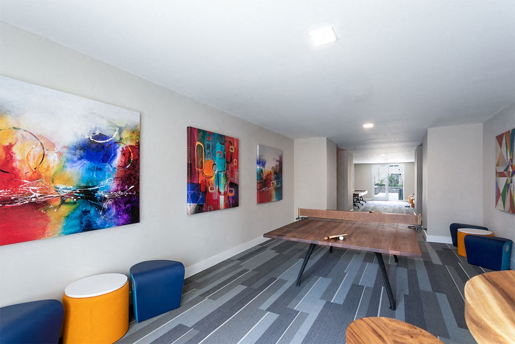 a conference room with a table and paintings on the wall at Aster Apartments, Beachwood, 44122