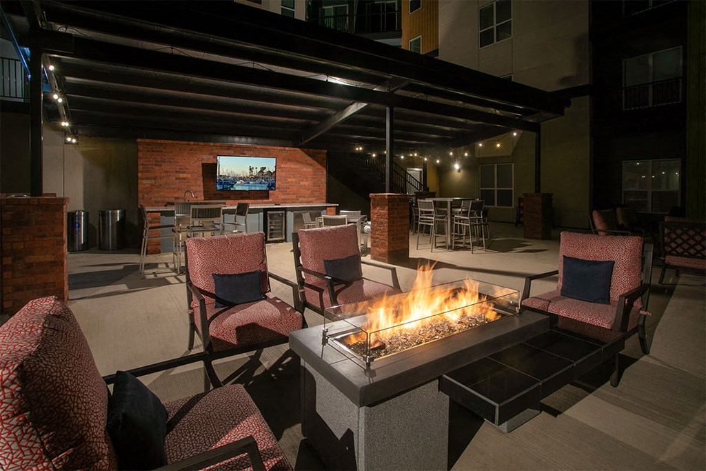 the lobby of the building has a fireplace and a wall of quilts at Aster Apartments, Beachwood, OH 44122
