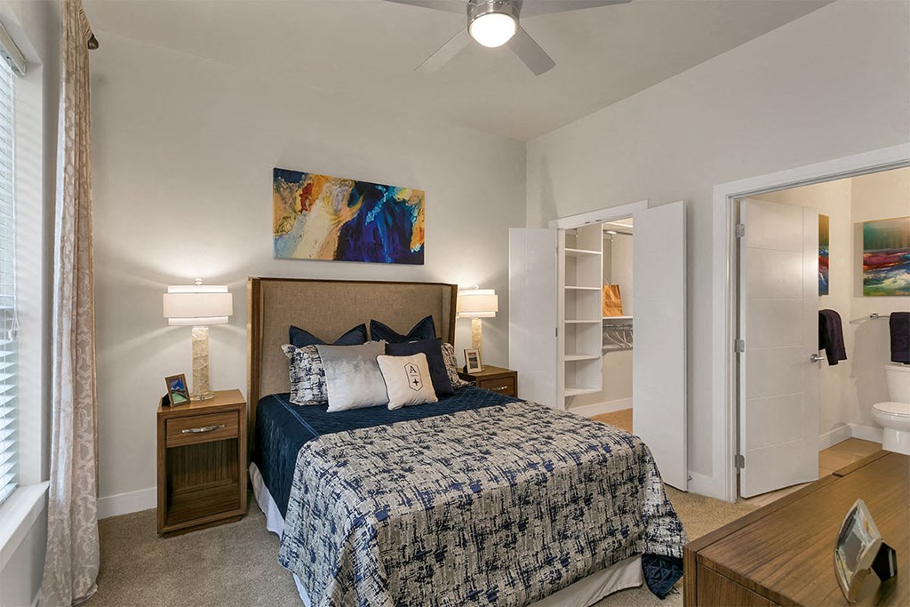 a bedroom with a bed and a ceiling fan at Aster Apartments, Beachwood