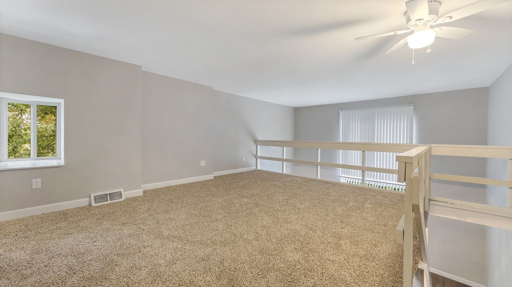 an empty room with a bunk bed and a ceiling fan