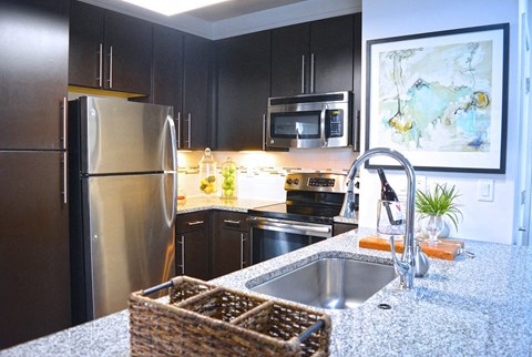 a kitchen with stainless steel appliances and granite counter tops