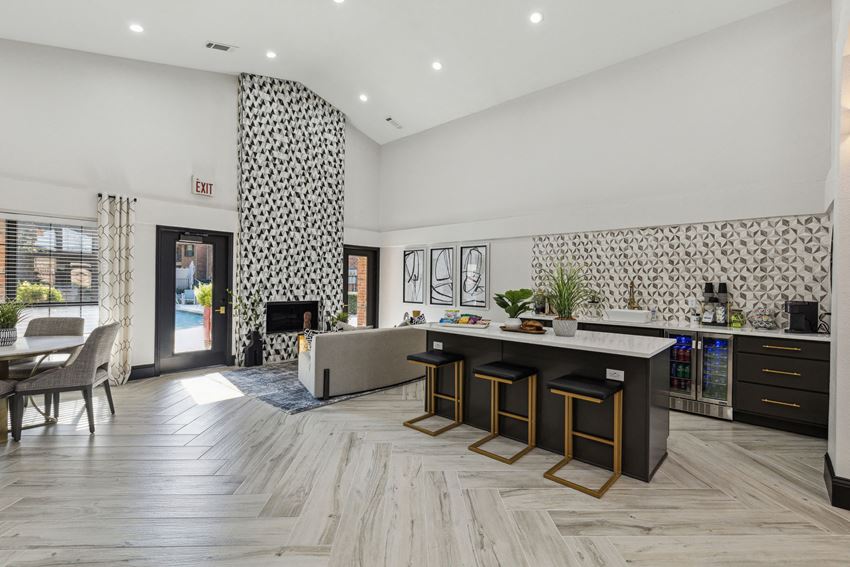 a living room with a kitchen and a fireplace