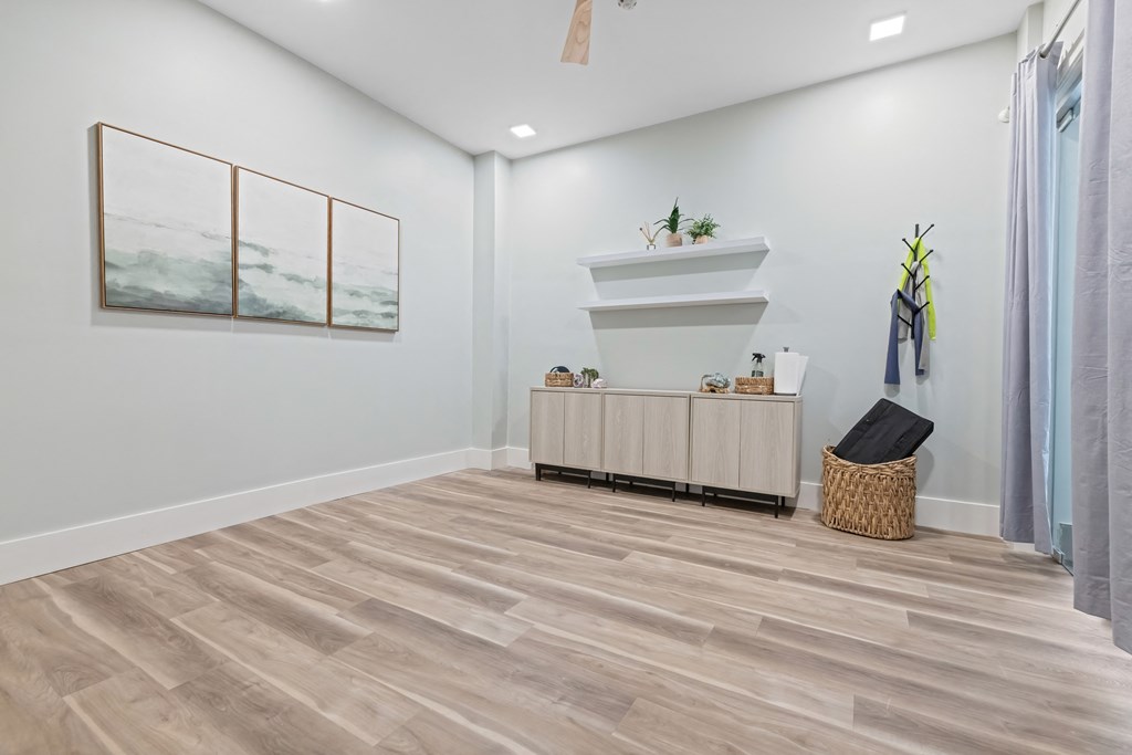 A room with a wooden floor and a painting on the wall at Aster Apartments, Beachwood Ohio