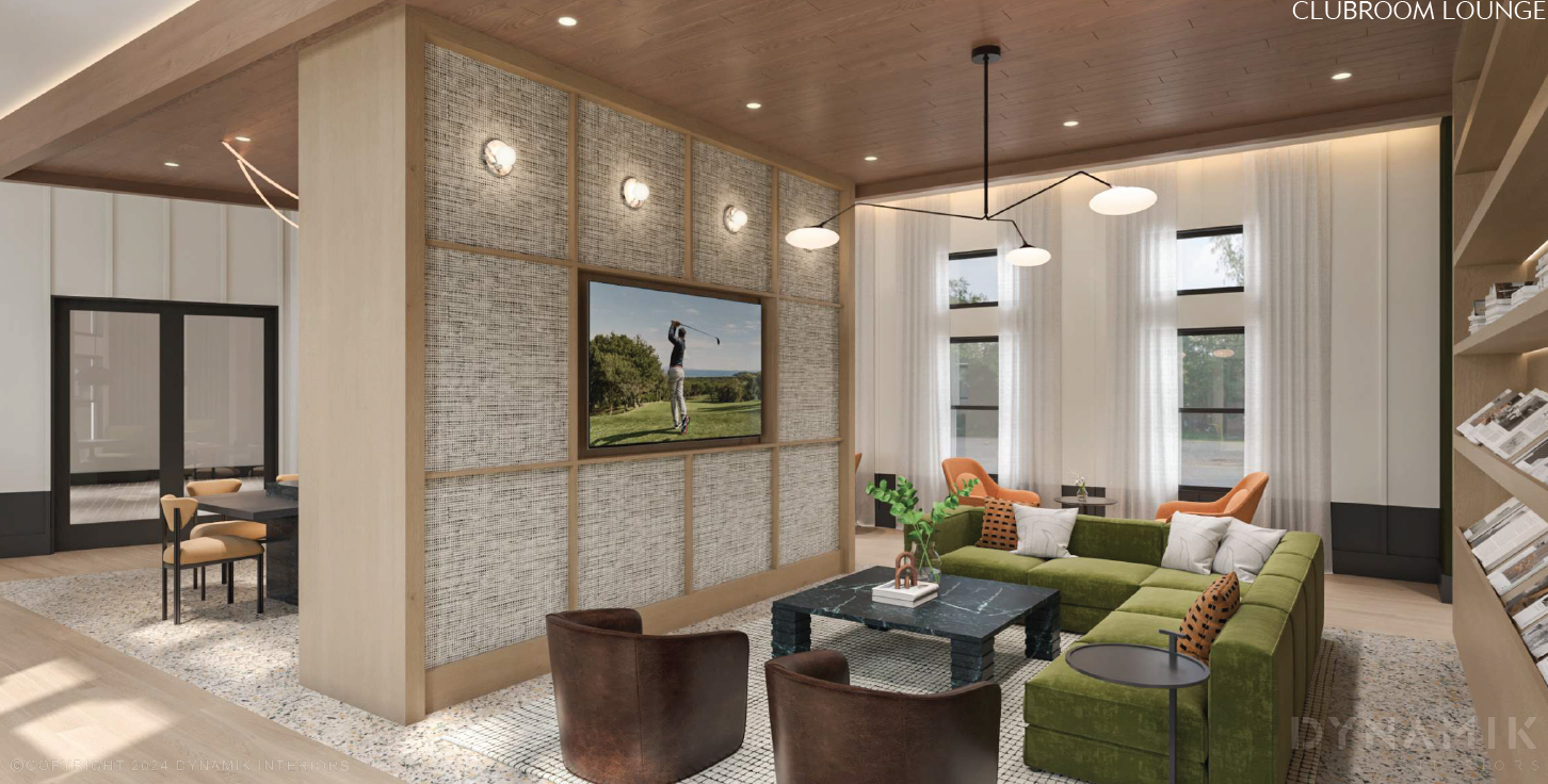 A modern living room with a green couch and a wooden floor.