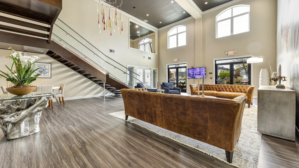 a living room with a couch and a staircase at Vanguard Crossing, St. Louis, Missouri