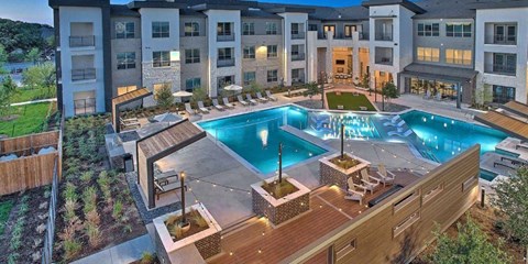 an aerial view of an apartment complex with a pool