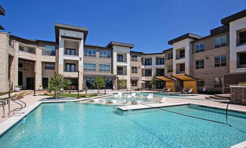 a large swimming pool in front of an apartment building at Hunters Creek Apartments, Denton