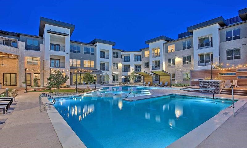 a large swimming pool in front of an apartment building at Hunters Creek Apartments, Texas