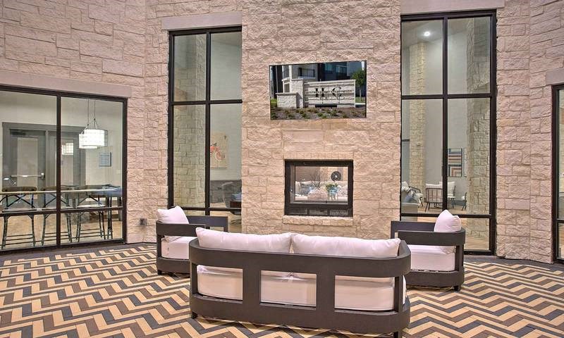 a room with a couch and a wall with a geometric design at Hunters Creek Apartments, Denton Texas